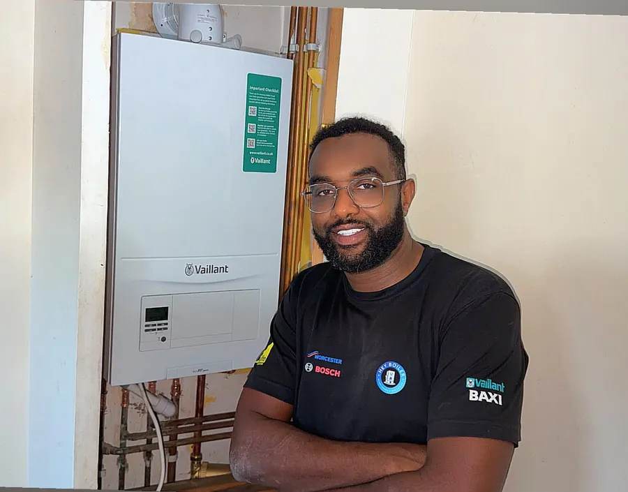 Hey Boiler engineer beside a newly installed Vaillant boiler