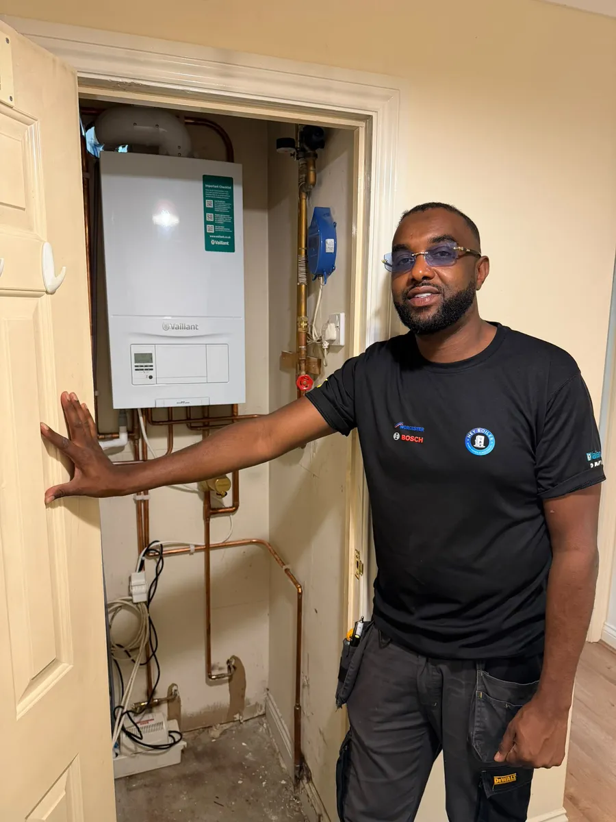 Hey Boiler engineer pointing out a newly installed boiler to a customer